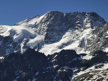 Scenic view of snowcapped mountains against clear sky