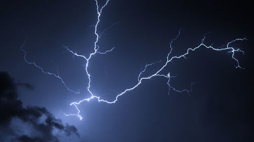 Low angle view of lightning in sky at night
