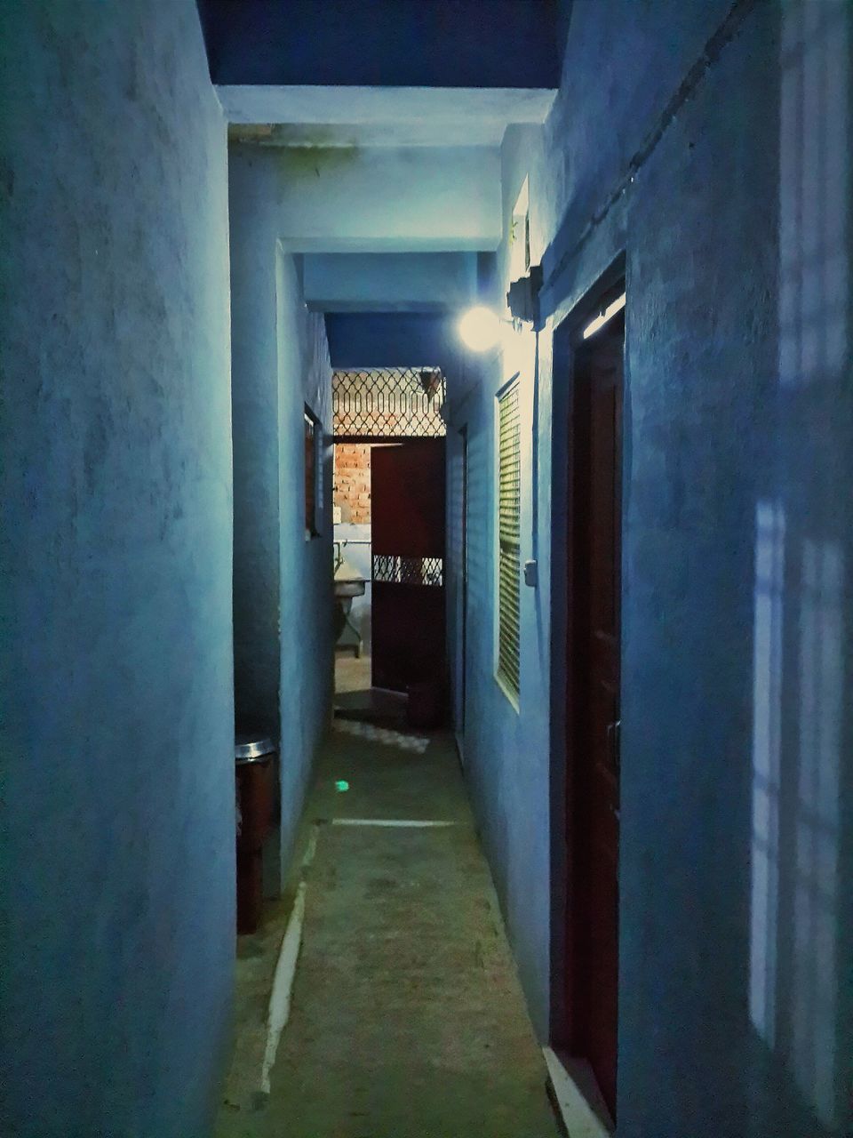 architecture, built structure, the way forward, corridor, building exterior, indoors, narrow, building, diminishing perspective, empty, alley, door, vanishing point, wall - building feature, illuminated, long, walkway, architectural column, wall, no people