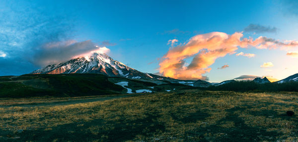 Scenic view of snowcapped mountain against sky during sunset