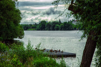 Scenic view of lake against cloudy sky