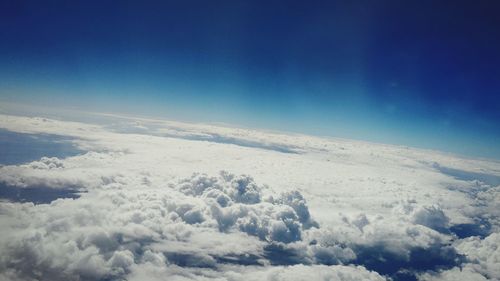 Scenic view of mountains against blue sky