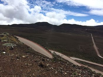 Scenic view of landscape against cloudy sky