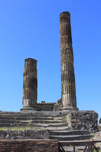 Low angle view of old building against blue sky