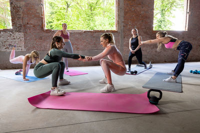 Friends exercising in gym