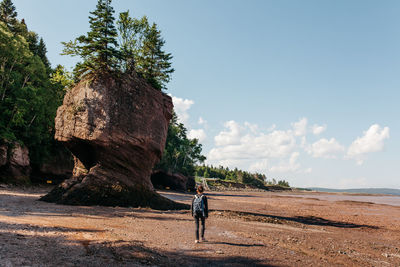 Full length of woman standing on landscape