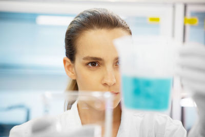 Close-up of young woman working in laboratory