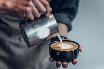 Cropped image of hand holding coffee cup