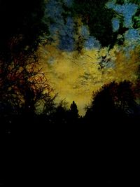 Low angle view of silhouette trees against sky at sunset