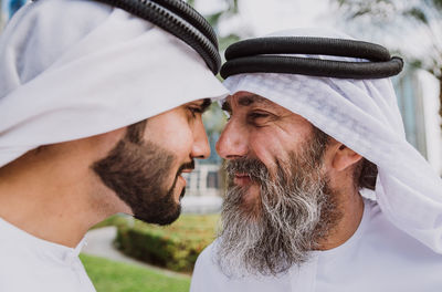 Close-up of male coworkers looking at each other