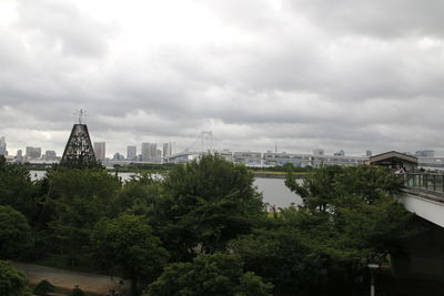 View of cityscape against cloudy sky