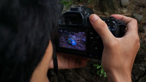 Midsection of woman photographing with mobile phone