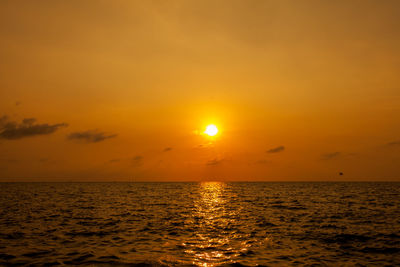 Scenic view of sea against orange sky