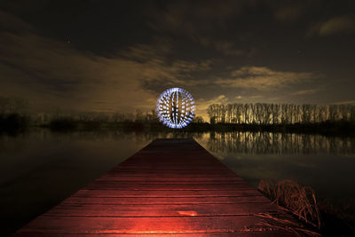 Scenic view of lake against sky at night