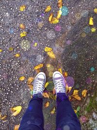 Low section of person standing on road