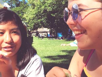 Close-up of smiling boy and woman in park