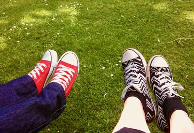 Low section of person wearing shoes on field