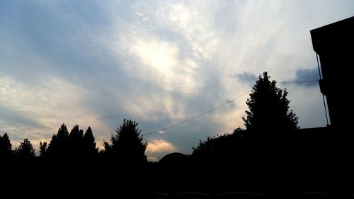 Silhouette trees against sky at sunset