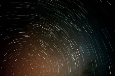 Low angle view of fireworks against sky at night