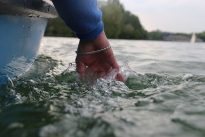 Midsection of person standing by sea