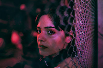 Close-up portrait of young woman at night