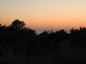 Scenic view of silhouette landscape against clear sky during sunset