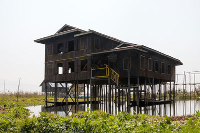 Exterior of abandoned building against clear sky