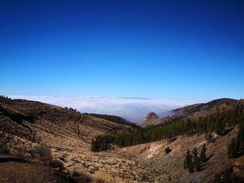 Scenic view of mountains against clear blue sky