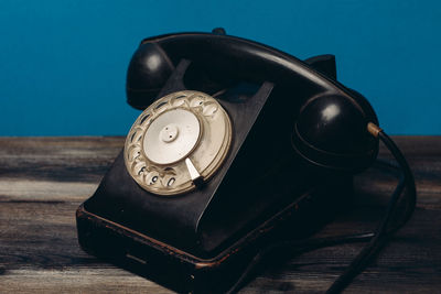 Close-up of old telephone on table