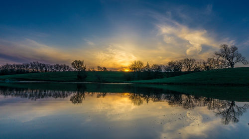 Scenic view of lake at sunset