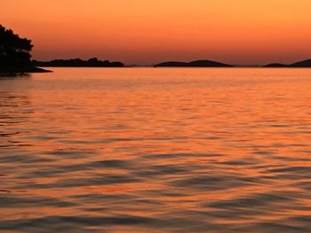 Scenic view of sea against romantic sky at sunset