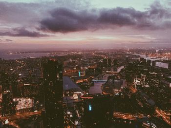 High angle view of illuminated city against sky at dusk