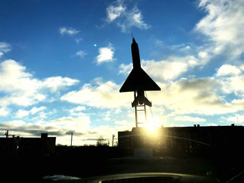 Low angle view of silhouette building against sky during sunset