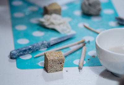 Close-up of pottery tools on table