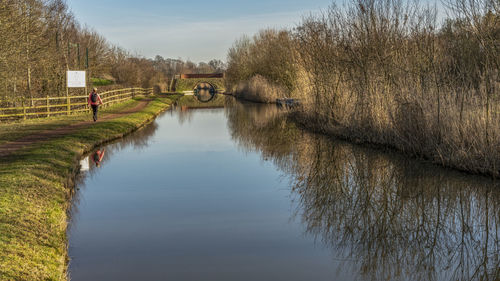 Rear view of woman by canal