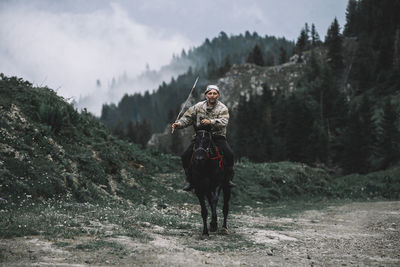 Portrait of man riding horse