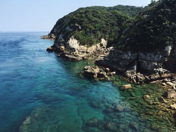 Scenic view of sea and mountain against sky