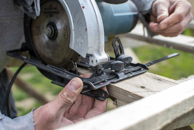 Cropped hands of man working in workshop