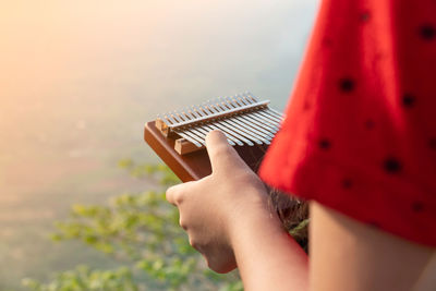 Close-up of woman hand holding a kalimba or mbira