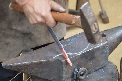 Cropped hand of manual worker holding hammer