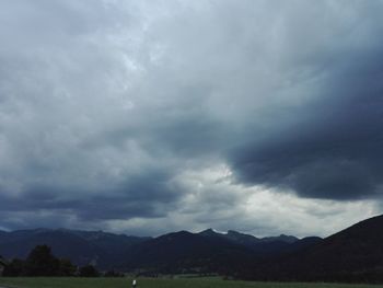 Scenic view of mountains against cloudy sky