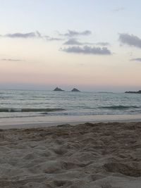 Scenic view of beach against sky during sunset