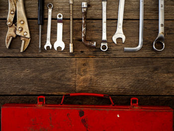 Directly above shot of hand tools and box on wooden table