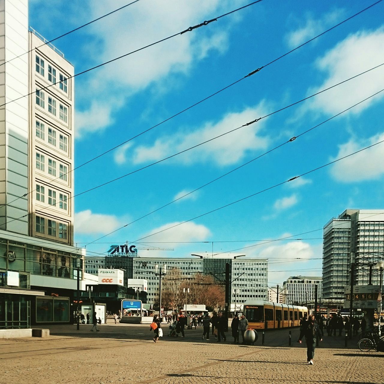 building exterior, architecture, built structure, power line, sky, city, cable, electricity pylon, cloud - sky, cloud, street, electricity, building, power supply, power cable, transportation, city life, connection, residential building, low angle view