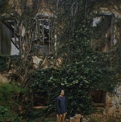 Woman standing on tree trunk