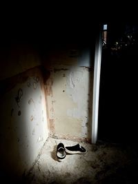 View of abandoned electric lamp on wall at night