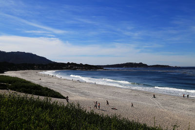 View of calm beach against blue sky