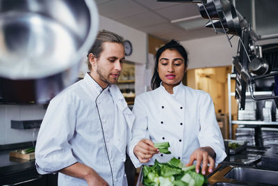 Young man and woman standing in kitchen