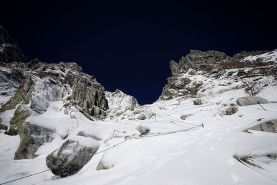 Scenic view of snowcapped mountain against sky at night