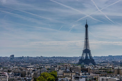 View of cityscape against cloudy sky